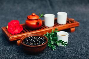 Traditional Chinese tea ceremony with black currant, fruit tea and healthy food. photo