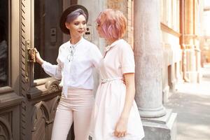 Two girls entering the building in the city photo