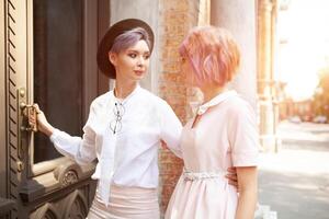 Two girls entering the building in the city photo