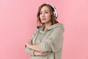 Woman listen music headphones  pink background studio shoot photo