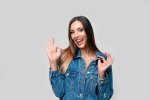 Beautiful caucasian girl in a denim jacket posing in the studio on a white background. photo