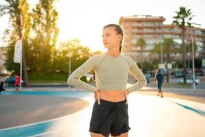 Sportive woman standing outdoor in city photo