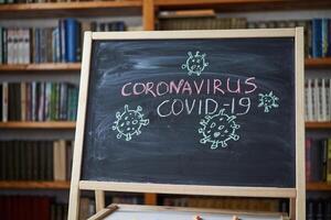 Outbreak Warning. written white chalk on blackboard in connection with epidemic of coronavirus worldwide. photo