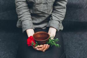 Woman offers hot tea in a vintage ceramic cup. photo