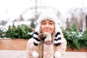 Winter portrait young adult beautiful blonde woman wearing funny fluffy hat. Christmas mood. Snowing winter beauty fashion concept photo