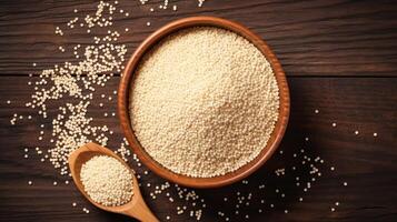 AI generated Bowl of raw couscous on a wooden background. Concept of Mediterranean cuisine, simple ingredients, and healthy grains. Top view. photo