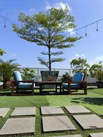 Surakarta, Indonesia, 2023 - A green garden at the rooftop with the square stone tiles photo