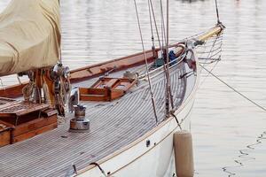 An image shows an old-fashioned yacht docked photo