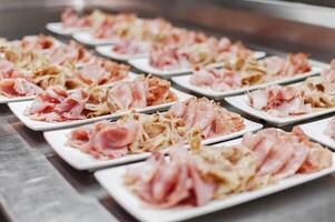 Serving plates with sliced ham photo