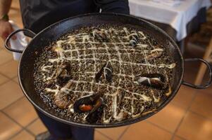 Paella with Black Rice and Seafood photo