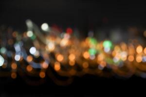 colorful bokeh light neon festive with dark black background photo