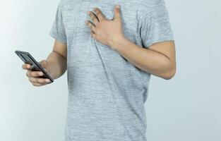 Asian man sending text message on smart phone on white Background photo