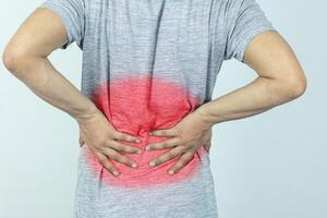 Man suffering from pain in the waist on a white background photo