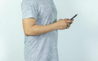Asian man sending text message on smart phone on white Background photo