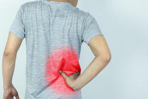 Man suffering from pain in the waist on a white background photo