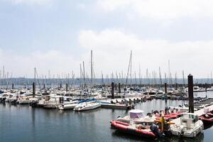 Brest, France 28 May 2018 Panoramic outdoor view of sete marina Many small boats and yachts aligned in the port. Calm water and blue cloudy sky. photo