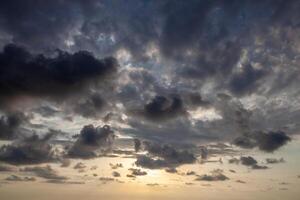 Fantastic sky, dramatic sunset, beautiful natural background. Setting sun illuminates the clouds. photo