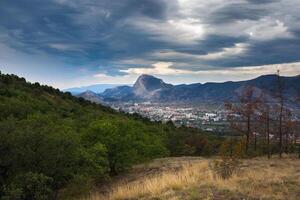 city  near the mountains under a beautiful sky photo