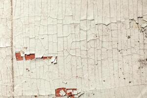 Cracked wall with old layers of paint in abandoned house photo