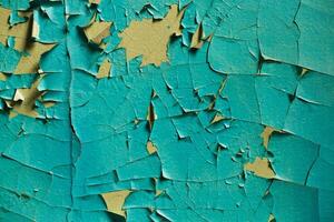 Cracked wall with old layers of paint in abandoned house photo