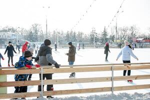 Ukraine, Kharkov 30 December 2018 People skate in the city park on Freedom Square. Excellent family leisure on weekends and holidays. photo