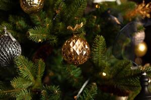 Close-up of a Christmas tree decorated with gold balls and blue bows. Christmas holiday concept photo