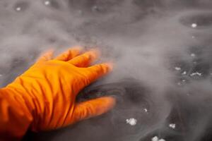 Thick white smoke on a background of black ceramic tiles. photo