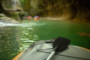 Kayaking on the river. group of people in a boat sailing along the river. Rowers with oars in a canoe. Rafting on a kayak. Leisure. photo