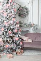 The Christmas tree in the room near the fireplace, the Christmas mood with gifts photo