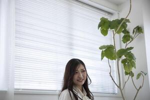 A relaxed Japanese woman by remote work in the home office photo