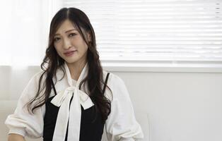 un relajado japonés mujer por remoto trabajo en el hogar oficina foto