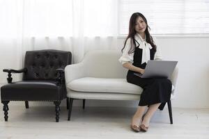 A Japanese woman checking smartphone by remote work in the home office photo