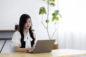 A working Japanese woman by remote work in the home office closeup photo