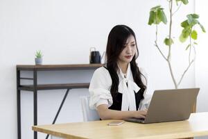 A working Japanese woman by remote work in the home office closeup photo