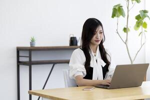 A working Japanese woman by remote work in the home office closeup photo