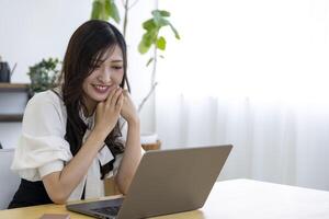 A working Japanese woman by remote work in the home office closeup photo