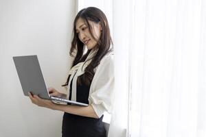 A working Japanese woman by remote work in the home office closeup photo