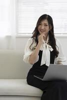 A working Japanese woman by remote work in the home office closeup photo