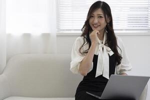 A working Japanese woman by remote work in the home office closeup photo