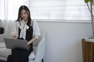 A working Japanese woman by remote work in the home office closeup photo