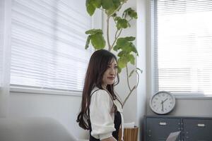 A working Japanese woman by remote work in the home office closeup photo