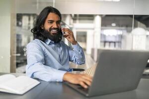 Millennial indian man business consultant have phone call with client photo