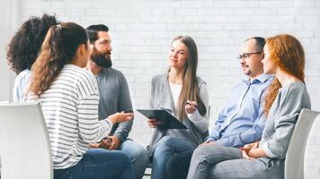 Patients listening to advices of female psychologist photo