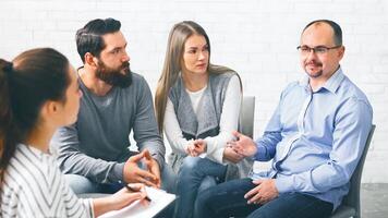 Group of patients talking at therapy session photo