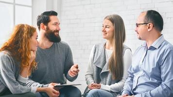 Therapist talking with patients during support group session photo