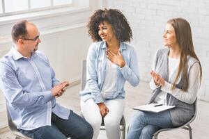 African woman appreciates support of millennials at rehab group meeting photo