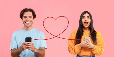 A smiling man in a light blue shirt holds his phone joyfully while a surprised young woman in a yellow sweater does the same photo