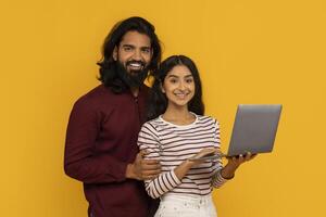 Couple with laptop possibly planning travel photo