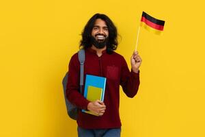 Positive eastern young man studying German at university photo