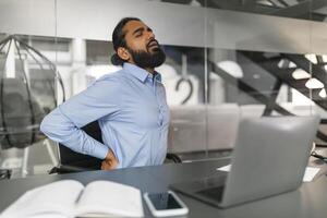 Businessman with hands behind head looking away photo